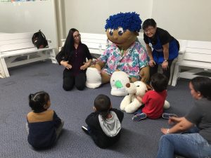 Members of the CSC Ohana Time group interact with Stuffee at Hawaii Children's Discovery Center.