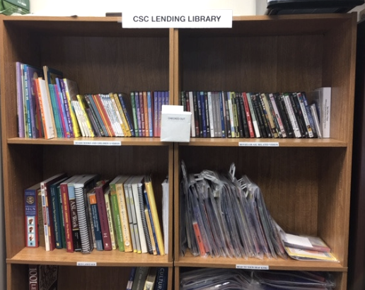 Bookshelf with books and videos. Text: Lending Library