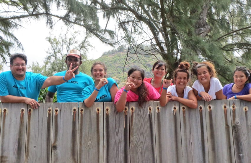 Photo: Camp counselors and participants pose for a photo with the wall 