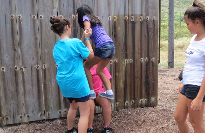 Photo: Camp participants help a student up the wall